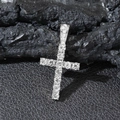 Close-up of silver iced out cross pendant with sparkling stones on dark textured stone - Silver Single Cross