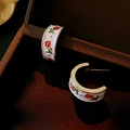 Macro view of C-shaped tulip enamel earrings on velvet inside a vintage wooden jewelry box - Tulip Flower C-shaped Stud Earrings