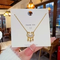 Golden titanium steel necklace featuring a hollow ruyi lock pendant with micro-inlaid stones - Ruyi Lock / Gold