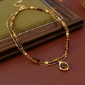 Dettaglio di perline in occhio di tigre e ciondolo a goccia su collana a strati - Set da 2 Pezzi - Caffè (Placcato Oro)