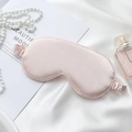 Pink satin silk sleep eye mask with matching elastic strap on a luxury white fabric background - Champagne Pink Eye Mask