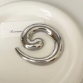 Close-up of a silver spiral stainless steel brooch with a polished mirror finish on a dish - 9# Silver Spiral Circle Brooch