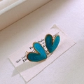 Detail shot of heart-shaped earrings with gold trim and blue enamel on white card - Light Blue (Marble Pattern)