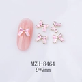 Détail macro d'un nœud rose en émail de 9x7mm avec bords dorés pour ongles - Nœud Bordure Dorée Rose Clair (8464)