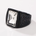 Macro shot of black stainless steel ring with a large rectangular clear gemstone and pattern - Black White Gem