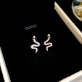 Macro shot of silver snake-shaped earrings with shimmering crystals on black velvet - 12# Silver Needle-Silver Zircon Small Snake Studs