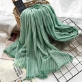 Green and white vertical striped cotton linen scarf with fine fringe on a woven basket - Light Green Stripe