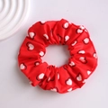 Close-up of red fabric scrunchie with white heart patterns and black outlines - Heart Series-6 (Red White Hearts)