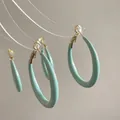 Detail of mint green resin C-shaped hoop earrings with polished gold-tone metal posts - 12# Silver Earring Post - Mint Green - C-Shape Hoop