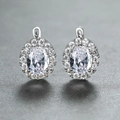 Elegant silver oval halo earrings with clear cubic zirconia pavé and white metal finish - White Gold With White Zirconia