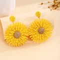 Detail showing the intricate woven texture and craftsmanship of sunflower earrings - Yellow