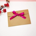 Minimalist kraft paper envelope featuring a bright fuchsia ribbon bow for gift cards - Envelope with Rose Red Ribbon