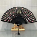 Elegant black folding fan featuring golden tigers, pink roses, and a sleek black tassel - Alluring Beauty