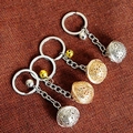 Detailed view of hollow sphere pendants and bells on gold and silver keychains - Multi-size / Gold Bell