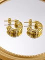 Macro shot of gold-plated C-shaped earrings with ribbed texture and sparkling crystals - Gold C-shaped Ribbed