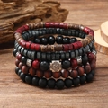 Retro multi-layer wooden bead bracelet set with silver cross pendant on a rustic surface - Red Snowflake 5-piece Set