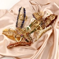 Detailed macro view of large golden alloy hair claws with inlaid natural crystal stones - Large B Style 11.5cm + Rose Quartz