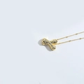 Golden bead chain necklace with a cubic zirconia paved letter X pendant on white background - Style Y