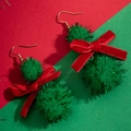 Detailed view of Christmas earrings with green pom-poms and red velvet bows on golden hooks - Green Double Pom Pom Red Bow