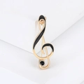Elegante spilla a chiave di violino dorata con smalto nero e dettaglio di perla - Oro