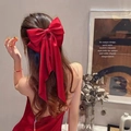 Elegant large red satin bow hair clip with long streamers on female model hairstyle - Red