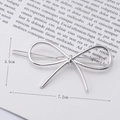 Close-up of a silver bow-shaped hair clip with 7.2cm length dimensions on minimalist card - Bowknot Shape Silver