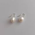 Detailed macro view of natural freshwater pearl earrings with elegant silver hooks - K96-Large 7-8mm