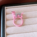 Pink poodle resin ring with rhinestone bow and pearl collar detail on velvet background - 45# Pink Puppy Ring