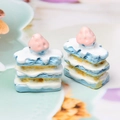 Macro shot of miniature resin strawberry Napoleon cakes in pink and blue for DIY crafts - Sea Salt Napoleon