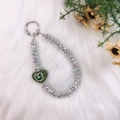 Silver rhinestone phone charm featuring a sparkling green heart-shaped pendant accessory - Green Heart Pendant