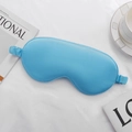 Sky blue faux silk sleep mask with elastic strap on white knit background with coffee cup - Lake Blue