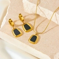 Minimalist gold stainless steel jewelry set with black square pendants on beige stone - Black Shell Necklace + Earrings Set