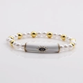 Elegant pearl and gold bead bracelet with a central blue evil eye enamel tube charm - White