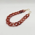 Macro detail of red marble resin chain with polished gold metal lobster clasps - Agate Fish Pink
