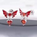 Macro shot of silver butterfly earrings with heart-shaped red zircon and fine wing details - Single Blood Butterfly