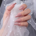 Macro shot of long coffin-shaped nude pink glossy finish press-on nails with lace detail - Nude Pink (ZBLL-09)