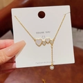 Gouden eekhoorn ketting met hart hanger, schelpinleg en witte parel detail - Goud Schelp Klaver