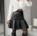 Detailed view of black PU leather mini skirt with ruffle hem on professional model - S / Black