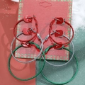 Three pairs of glitter Christmas hoop earrings in festive red, green, and silver colors - 20 3-Pair Glitter Hoop Set