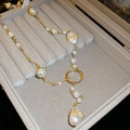 Vintage gold necklace featuring baroque pearls displayed in a grey jewelry gift box - Baroque Pearl Metal Ring Pendant Necklace