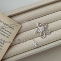 Elegant S925 silver flower necklace with hollow petals and zircon on a beige tray - 925 Silver / Hollow Flower Necklace(XLV020)