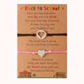 Detail of two back to school heart charm bracelets on kraft paper cards for mother and daughter - Pink + Black