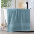 Thick premium cotton bath towel in duck egg blue draped over a white bathtub - Herringbone Border Hand Towel (Duck Egg Green) / 34*74cm