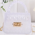 Mini PVC jelly bag with leaf pattern, gold twist lock and woven handle in frosted white - White