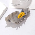 Detail of eagle-shaped hair claw clip in grey marble acetate with yellow beak accent - Shoebill