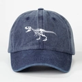 Vintage washed navy baseball cap featuring a white dinosaur skeleton print and adjustable strap - Navy Blue