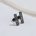 Macro detail of matte black rectangular earrings with moon phase cutout patterns - Black
