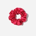 Macro detail of glossy magenta satin scrunchie showing silky texture and elegant folds - Burgundy