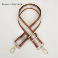 Close-up of adjustable brown and silver striped nylon strap with gold metal hooks - Brown + Gold Hook