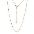 Dettaglio del ciondolo Ankh su catena in acciaio dorato con eleganti perline blu - Oro Perline Blu Mare
